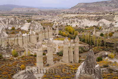 Fairy chimney rock formations in Goreme National Park with Cavusin Turkey in the distance