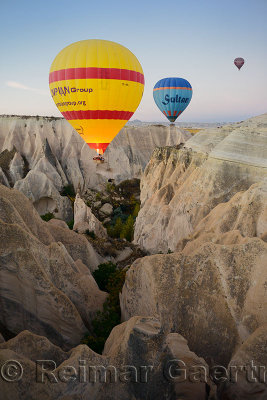 Hot air balloon with propane heater over a steep canyon of eroded volcanic tuff in Cappadocia Turkey
