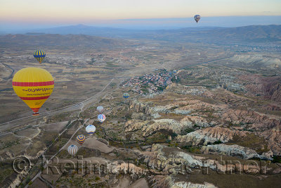 View of Cavusin and Avanos in the distance from a hot air balloon over Rose Valley Cappadocia Turkey