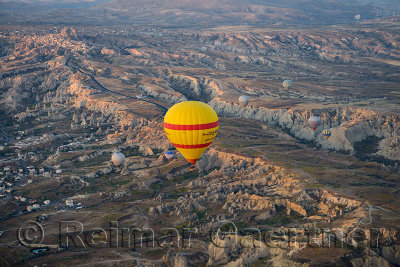First light on Goreme Historical National Park and Uchisar from hot air balloon Cappadocia Turkey