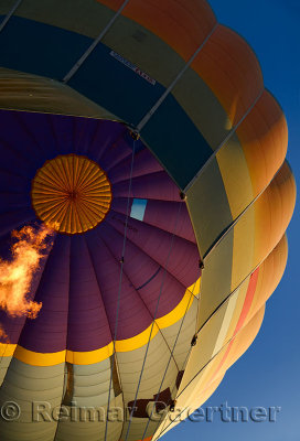 View up into a hot air balloon envelope being inflated with flame from propane heater in Cappadocia Turkey