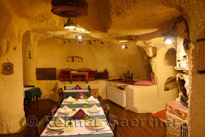 Interior of Urgup Evi rock house cave hotel dining room carved out of volcanic tuff in Cappadocia Turkey