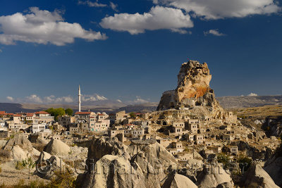 Broad view of Ortasihar rock Castle with minaret Mount Erciyes and fairy chimneys Cappadocia Turkey