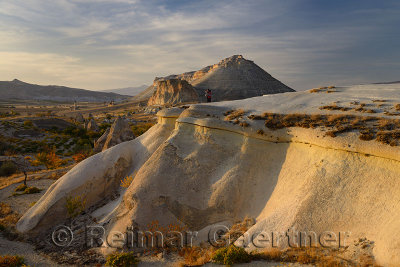 Tourists viewing landscape at Pasabag Monks Valley at sunset Cappadocia Turkey