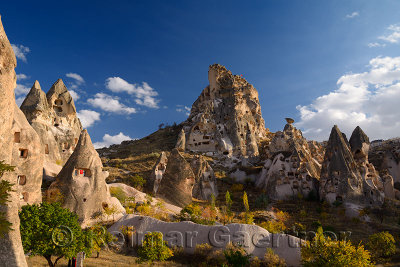 Ancient Uchisar Castle houses and tunnels at sunset carved out of volcanic tuff Cappadocia Turkey