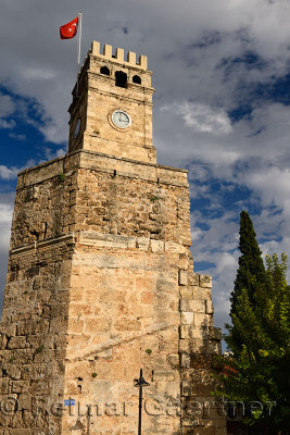 Saat Kulesi Clock Tower with Turkish flag on Roman wall in Castle Gate area of Antalya Turkey