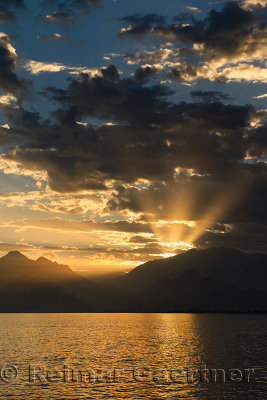 Mediterranean Sea at Antalya harbour Turkey with sunset God Rays over mountains