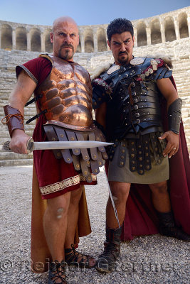 Roman Gladiators scowling before sword fight on stage at Aspendos theatre Turkey