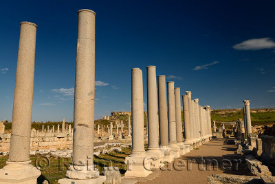 View north to Perge Turkey Acropolis from colonade of pillars at Agora with circular temple