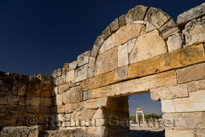 Ancient columns with lintel of Greco Roman temple seen through the stone block south gate at Hieapolis Turkey