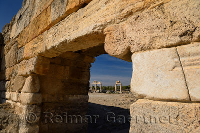 Ancient Roman columns with lintels seen through the stone block south gate at Hieapolis Turkey