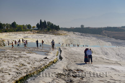 Visitors and tourists at the travertine terraces and thermal pools of Pamukkale Turkey
