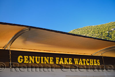 Ironic sign for genuine fake watches at the entrance to the ancient city of Ephesus Turkey