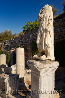 Marble statue on pedestal at ruins on Curetes Street of ancient Ephesus Turkey