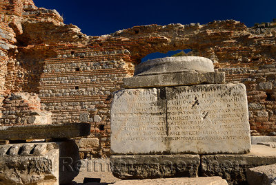 Greek inscription on stone column base at the brothel wall at Curetes and Marble streets Ephesus Turkey