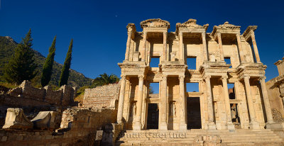 Panorama of ruins of the facade of the Library of Celsus with moon in blue sky at ancient city of Ephesus Turkey