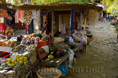 Woman knitting by streetside gift and craft shops in the hillside village of Sirince Turkey