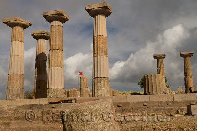 Six Greek columns and Turkish flag at acropolis ruins of Temple of Athena Assos Behramkale Turkey