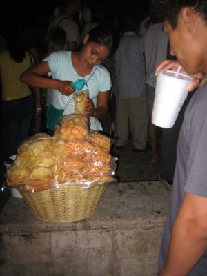 this little girl squeezes fresh lime and peppers up your chips for 15 pesos