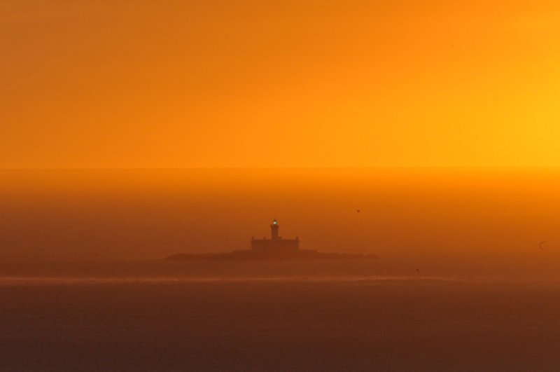 Lighthouse in the Sunset Mist