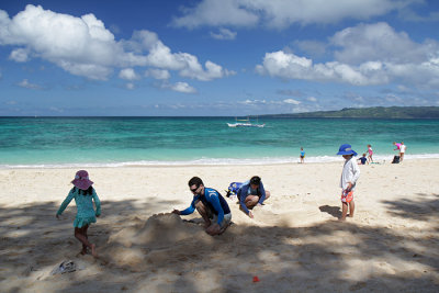 Building sand castles, Puka Shell Beach
