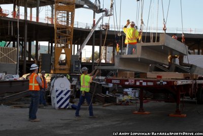 Construction works lift a 35,000-pound precast concrete piece at the new 49ers stadium