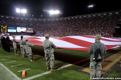 Active-duty service members bring out the American flag
