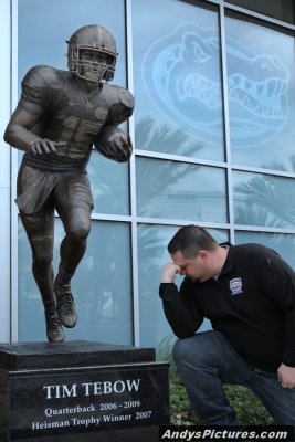 Tebowing in front of the Tim Tebow sculpture