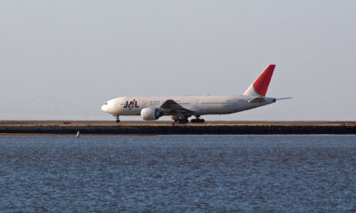 JAL B777 awaits clearance for departure in the evening light