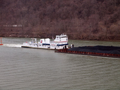 Towboat pushing barge of coal