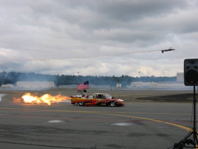a truck with a jet engine about to race that plane, and win