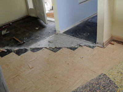 Tearing out old tile under carpeted area. 