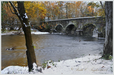 Autumn Snow Along 8 Arch Stone Bridge