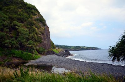 Remote black sand and lava rock beach
