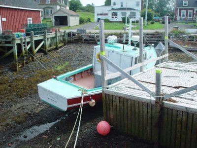 A BOAT AT ANNAPOLIS ROYAL AT LOW TIDE-IT IS AMAZING THAT THEY DON'T FALL OVER