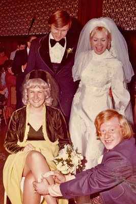 Ron puts the garter on my sister, Jeanette