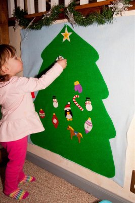 Decorating her own felt Xmas tree