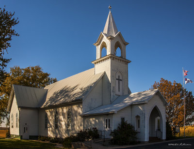 A rural church comes a live on a bright autumn day.
An image may be purchased at http://edward-peterson.artistwebsites.com/featured/st-johns-lutheran-church-edward-peterson.html