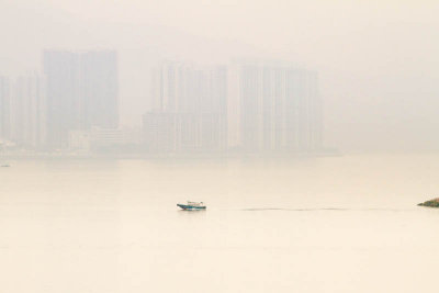lone boat in smoggy harbour  