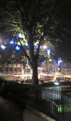 Christmas  lights  twixt  market  and  graveyard.