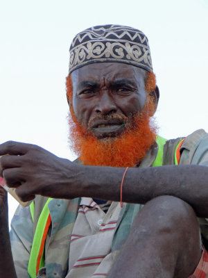 His orange beard signifies his having done the Haj (trip to Mecca).