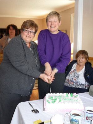 Two original members Margaret & Anne Marie cut the cake