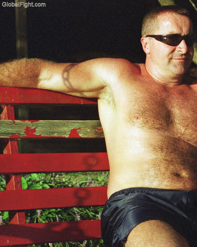 hot man sitting park bench jogging shorts.jpg