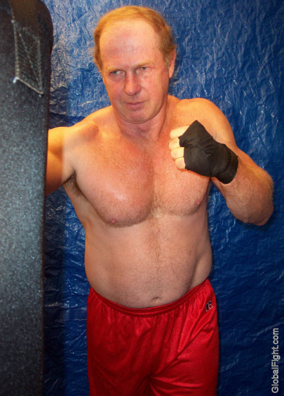 boxing bag workout husky older man.jpg