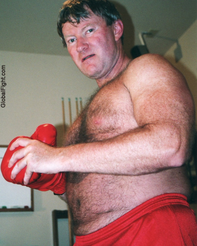 hairy boxer beefy guy putting on gloves.jpg