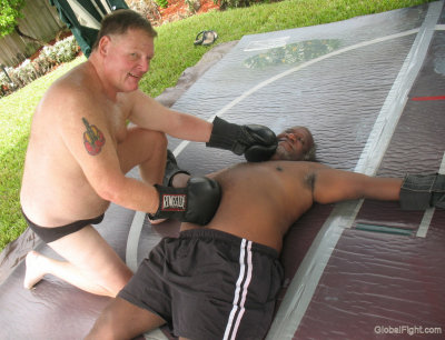 boxer dad posing over knoked out man.jpg