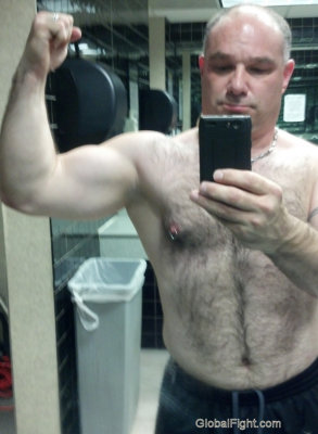 big gay powerlifter showing his big arms.jpg