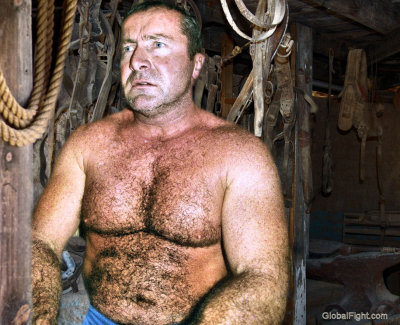 a hot rancher man sitting shirtless woodshed.jpg