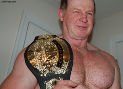 gray haired older fighting champion holding trophy.jpg