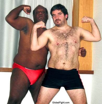 couple gay wrestlers flexing arms hairychests.jpg